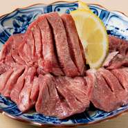 焼肉に使われるのは、九州産のA5ランク黒毛和牛。写真は、素材の旨みが際立つ逸品、看板メニューのひとつ『厚切りタン』です。上質でおいしい肉をリーズナブルな価格で楽しめます。