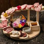 上タン、上ロース、上ハラミ、赤身など、こだわりの13～14種類のお肉が、それぞれ2枚ずつ美しく階段仕立てに盛付けられています。見た目の華やかさはもちろん、味わいも格別です。