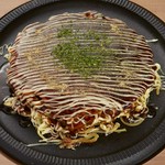 お好み焼きと焼きそばを合わせた関西のソウルフード！こて吉では、太麺の焼きそばとお好み焼きの生地を卵でつなぎ、ボリューム感あふれる外見と、それに違わない食感が特徴の逸品となっています。