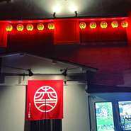 住宅街の中にある古民家をリノベーションしてつくられた【赤川三丁目酒場】。店の前は十字路になっており、真っ赤な暖簾や提灯が下げられているので遠くからでも目立ちます。