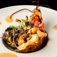 華麗な技で、活のオマール海老と蝦夷鮑のおいしさを昇華。蒸し焼きにすることでオマール海老はプリプリとした食感となり、蝦夷鮑はやわらかく濃厚な旨みがグッと増しています。（HISUIコースの一例です）