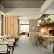 カウンター席と一部のテーブル席からは、存在感のある大きな銅製の薪窯が見えるようなデザインに。店内はナチュラルで洗練された空間が形づくられており、インテリアやカトラリーに対するこだわりも際立っています。