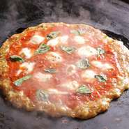 おかずではなくメインとして楽しめるライスもんじゃです。味の再現はスタッフにお任せでOK。もんじゃでマルゲリータが味わえます。
トマト・バジル・モッツァレラチーズ・米